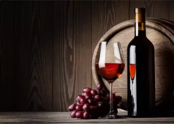 How is wine acidity described?